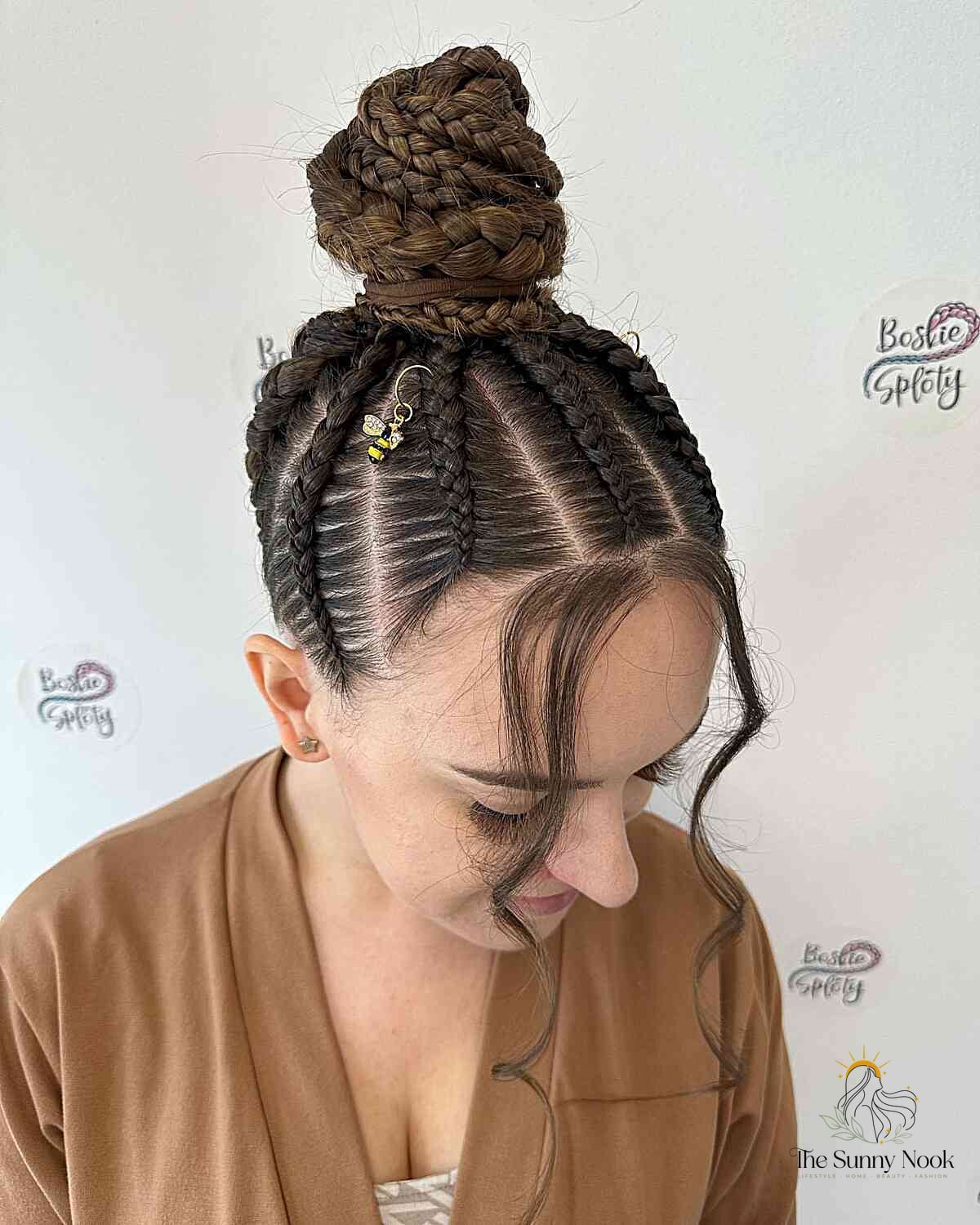 27 Slick Bun Hairstyles We're Obsessed With Right Now 6 Braided Triangles and Top Bun Updo