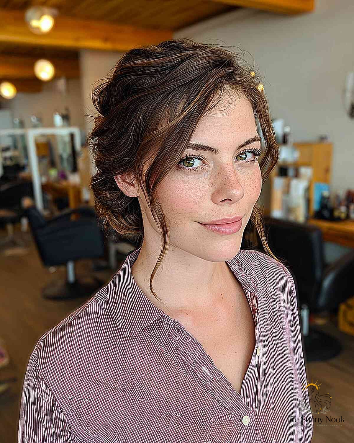 27 Slick Bun Hairstyles We're Obsessed With Right Now 10 Effortless Messy Bun with Face-Framing Strands
