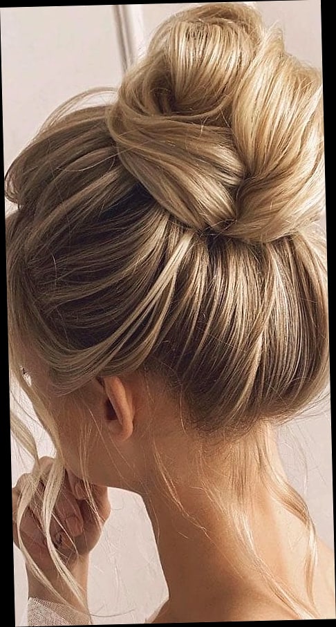 15 Hair Updos For Medium Hair to Transform Your Look Instantly 16 High Bun With Face-Framing Curls