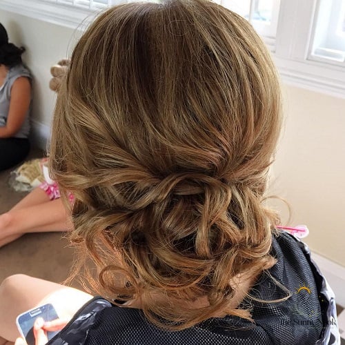 12 Side Bun Hairstyles We're Obsessed With Right Now 11 Loose and Curly Bun