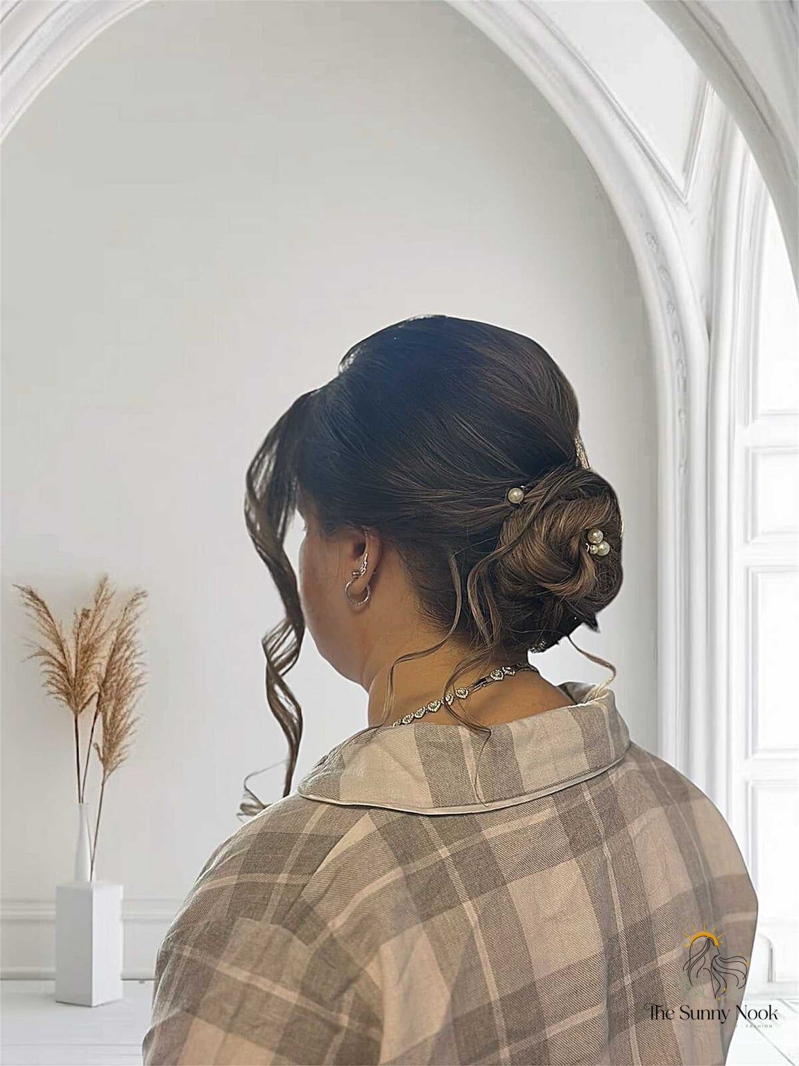 11 Low Bun Hairstyles For Black Women That Are Trending on Pinterest This Week 8 Pearl-Pinned Textured Knot on Dark Hair with Warm Undertones
