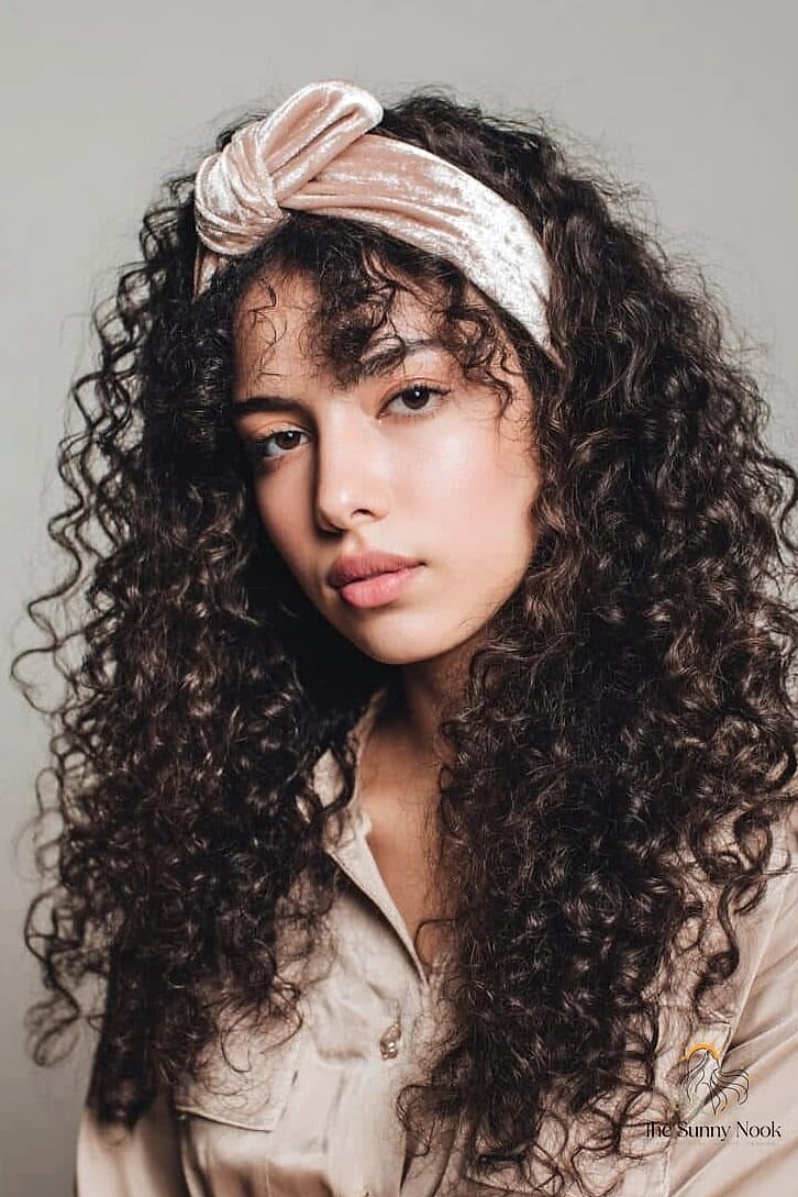 21 Headband Hairstyles Curly Hair Everyone Is Pinning Right Now 12 Sleek Center-Part With a Thick Satin Headband