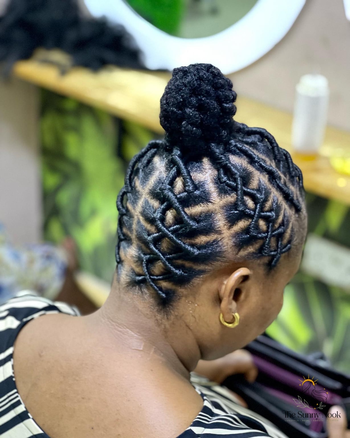 13 Small Braids Hairstyles We're Obsessed With Right Now 6 Twisted Bun with Geometric Braids Leading Into It