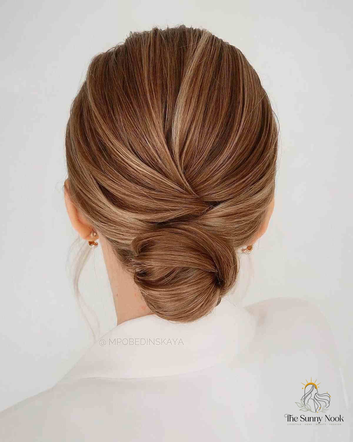 27 Slick Bun Hairstyles We're Obsessed With Right Now 12 Twisted Low Bun