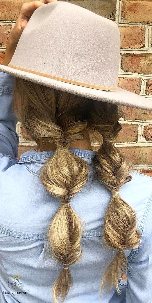 23 Cute Hat Hairstyles That Are Trending on Pinterest This Week 16 Braided Pigtails Under a Bucket Hat