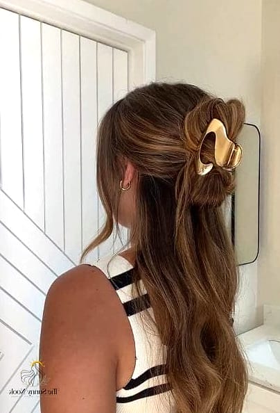 10 Easy Claw Clip Hairstyles We're Obsessed With Right Now 11 Claw Clip Half Bun for Curly Hair