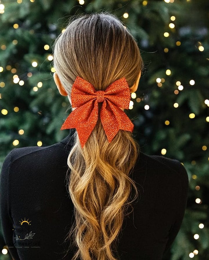 23 Cute Christmas Hairstyles That Are Actually Easy to DIY 12 Low Ponytail with a Wrapped Strand