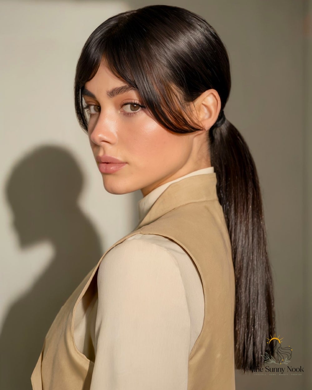 17 Long Thick Hair Hairstyles That Are Both Cute and Low Maintenance 7 Low Ponytail With Thick Curtain Bangs