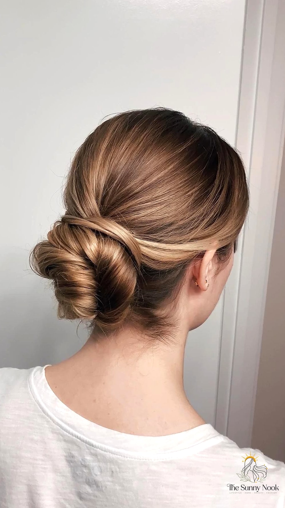 22 Classy Updo Hairstyles That Prove This Trend Is Here to Stay 13 Low Twisted Bun with Soft Waves
