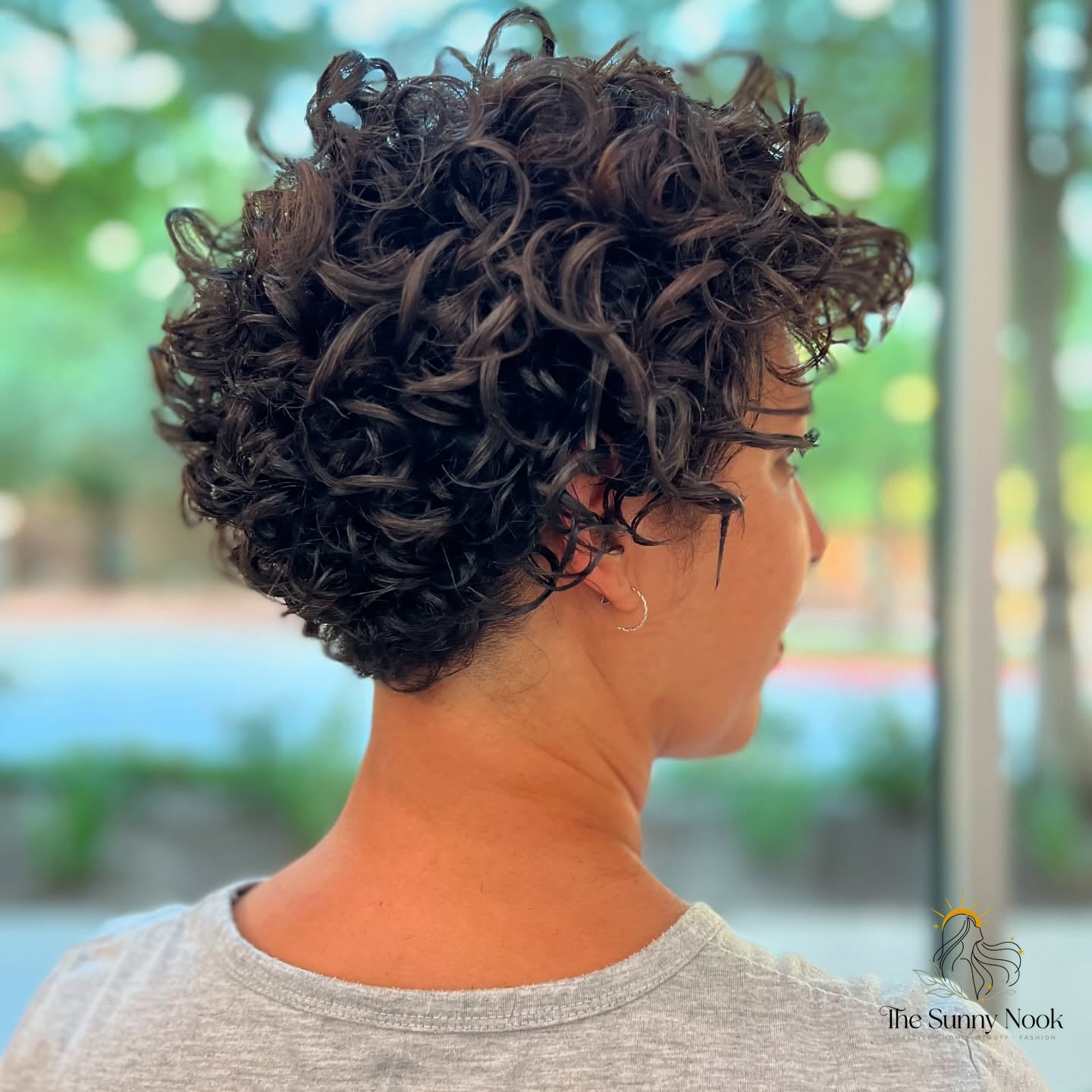27 Hairstyles For Curly Hair Short Perfect for Your Next Salon Appointment 7 Modern Curly Pixie with a Tapered Back