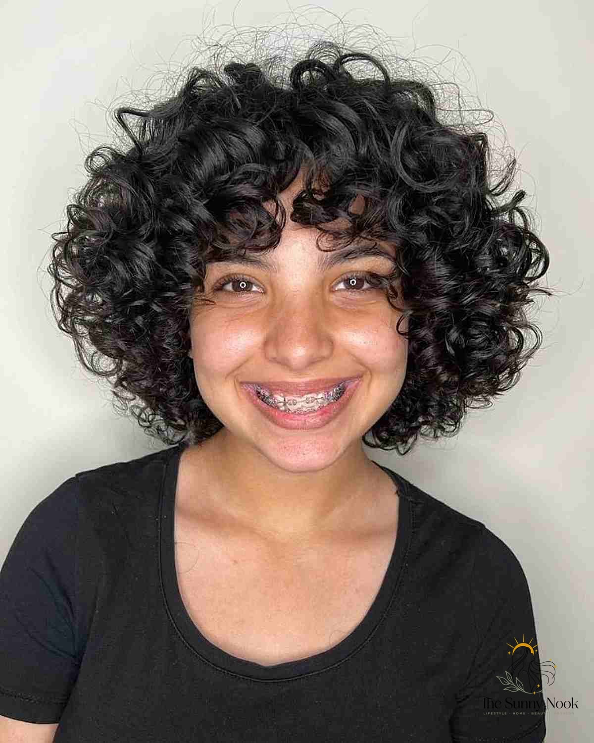 27 Hairstyles For Curly Hair Short Perfect for Your Next Salon Appointment 23 Round-Shaped Layered Bob with Bouncy Curls
